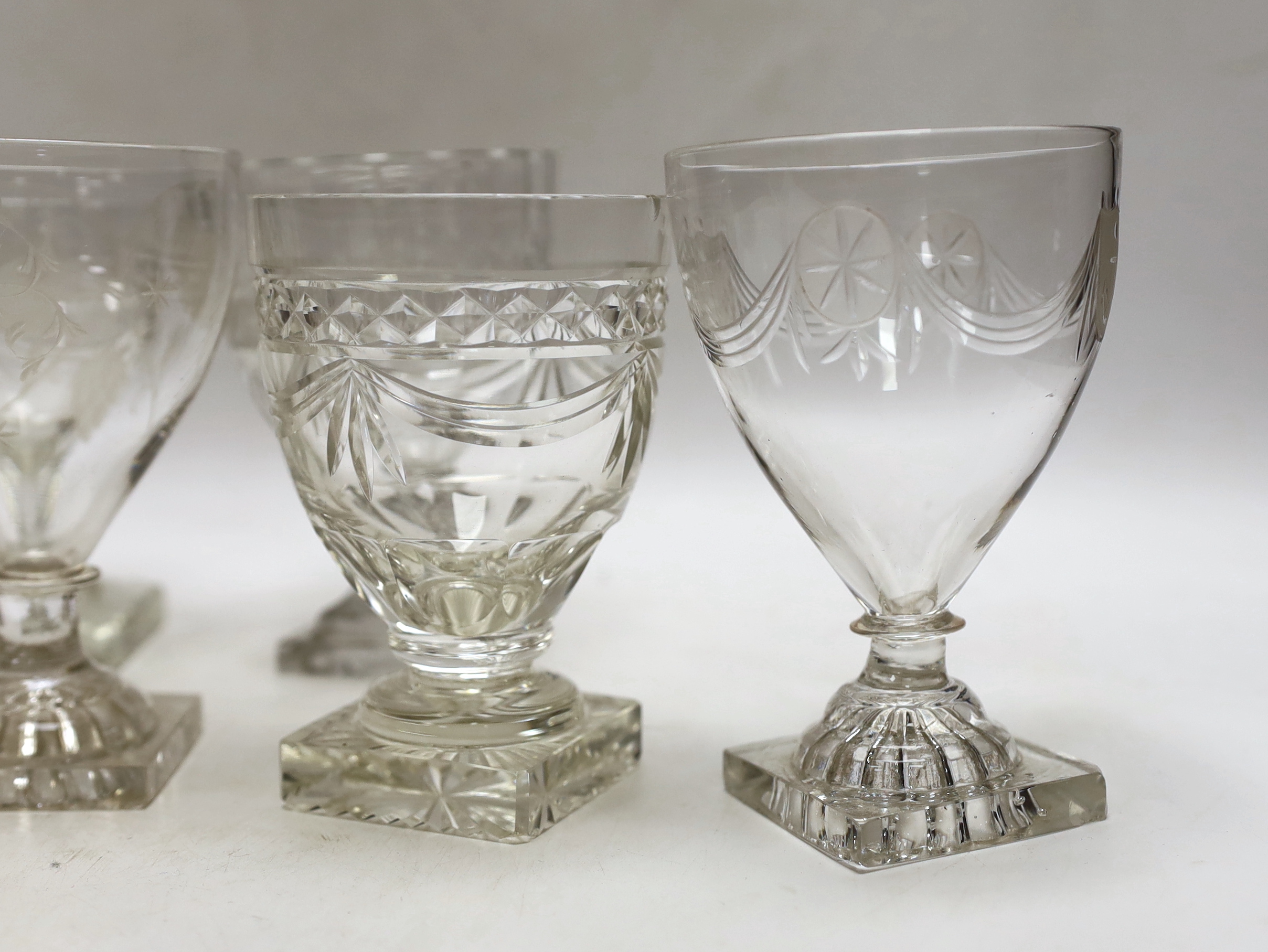 Three late 19th early 20th century square base wine glasses, three similar etched glasses and another (8)